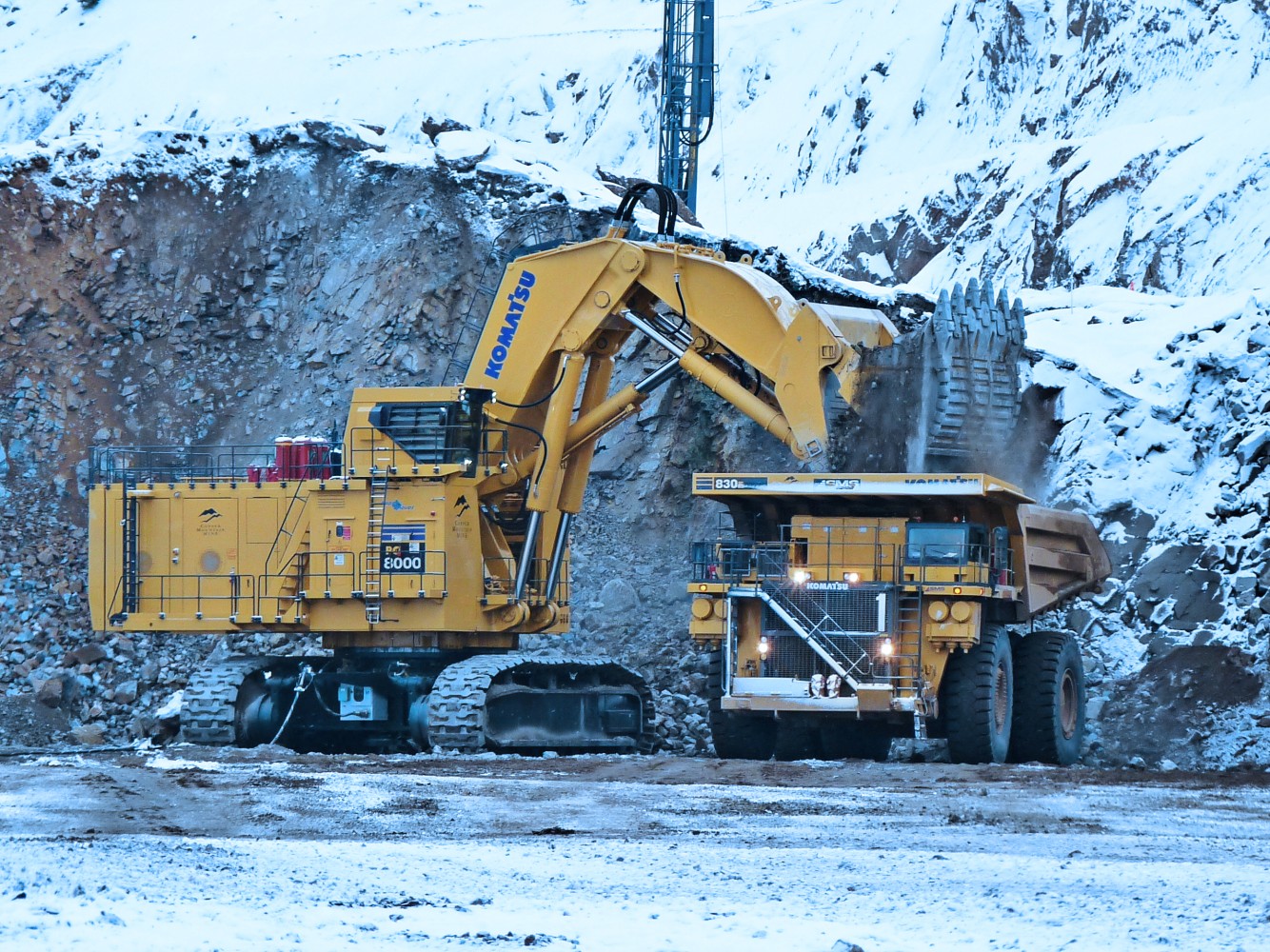 Excavators in front of a mountain